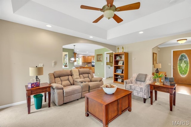 61 Serenity Ln, Troy, MO 63379 - living room with arched walkways, recessed lighting, light colored carpet, a ceiling fan, and a tray ceiling
