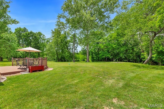 61 Serenity Ln, Troy, MO 63379 - view of green lawn with a deck and view of wooded area