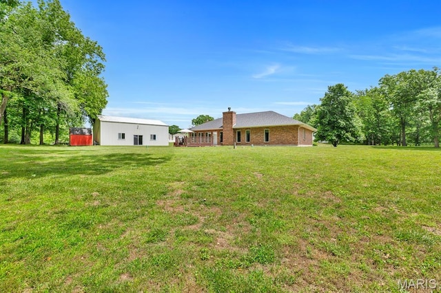 61 Serenity Ln, Troy, MO 63379 - back of house with a lawn and a chimney