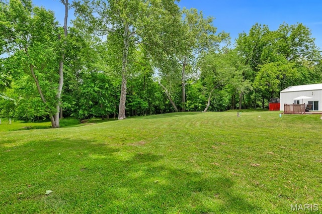 61 Serenity Ln, Troy, MO 63379 - view of grassy yard featuring a deck and view of wooded area