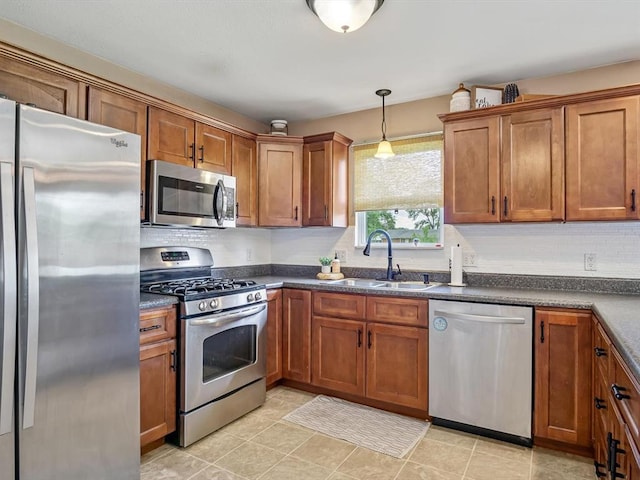 628 Hailie St, Saint Libory, IL 62282 - kitchen featuring stainless steel appliances, a sink, dark countertops, brown cabinets, and decorative backsplash