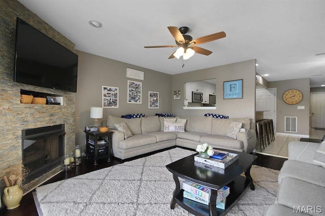 4800 Eagleview Dr Unit 113B, Osage Beach, MO 65065 - living area with a ceiling fan, wood finished floors, a stone fireplace, recessed lighting, and baseboards