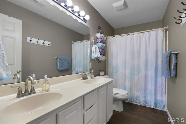 4800 Eagleview Dr Unit 113B, Osage Beach, MO 65065 - full bath featuring toilet, wood finished floors, double vanity, and a shower with curtain