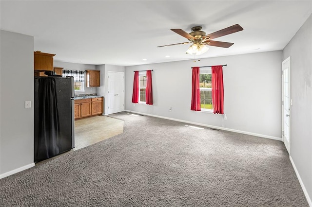 209 S Pence St, East Alton, IL 62024 - unfurnished living room featuring baseboards, light carpet, a ceiling fan, and recessed lighting
