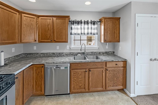 209 S Pence St, East Alton, IL 62024 - kitchen with appliances with stainless steel finishes, a sink, brown cabinetry, dark countertops, and recessed lighting
