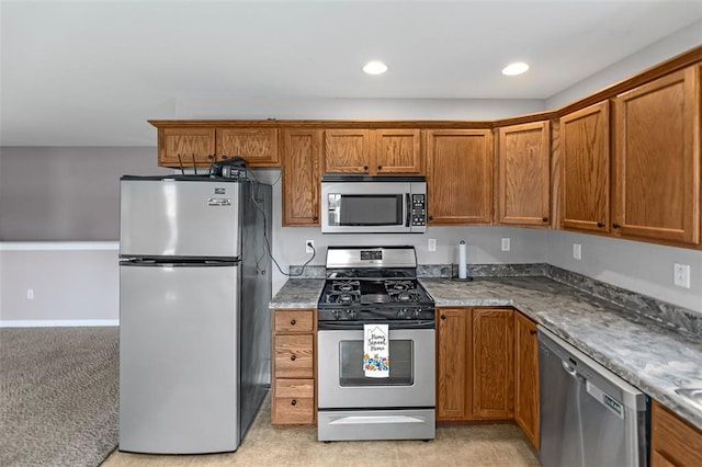 209 S Pence St, East Alton, IL 62024 - kitchen featuring appliances with stainless steel finishes, brown cabinetry, and recessed lighting