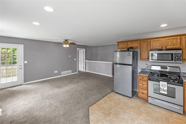 209 S Pence St, East Alton, IL 62024 - kitchen featuring stainless steel appliances, a ceiling fan, recessed lighting, brown cabinets, and baseboards