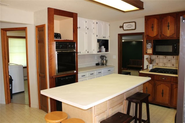 20143 State Highway 34, Piedmont, MO 63957 - kitchen with black appliances, light floors, decorative backsplash, and open shelves