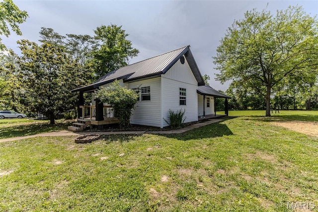 711 Noe Dr, Richland, MO 65556 - view of side of property with metal roof and a lawn