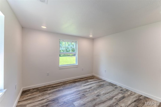 711 Noe Dr, Richland, MO 65556 - empty room featuring wood finished floors, baseboards, and recessed lighting
