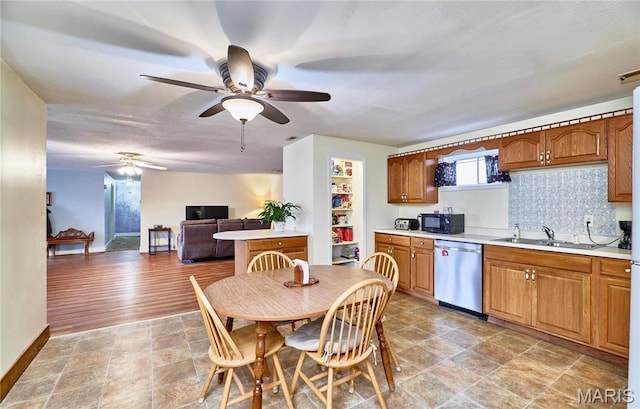 24925 Pike 244, Clarksville, MO 63336 - kitchen with dishwasher, black microwave, a ceiling fan, light countertops, and baseboards