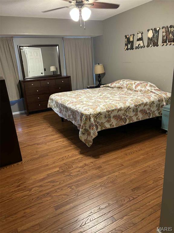 16 S Lang Dr, Ofallon, MO 63366 - bedroom with wood finished floors and a ceiling fan