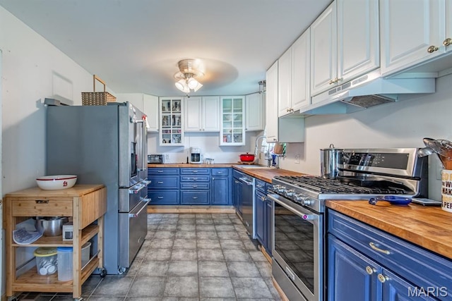 1956 Parkton W Dr, Barnhart, MO 63012 - kitchen featuring wood counters, appliances with stainless steel finishes, blue cabinets, and under cabinet range hood