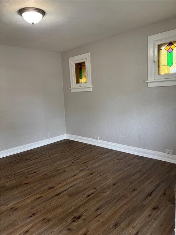 8324 Strathmore Pl, Jennings, MO 63136 - unfurnished room featuring baseboards and dark wood-type flooring