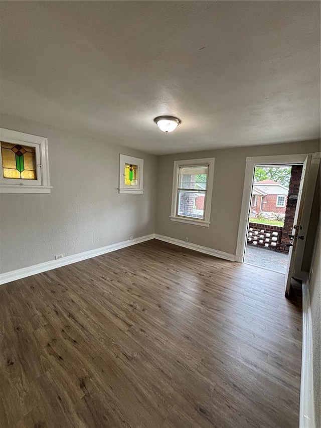 8324 Strathmore Pl, Jennings, MO 63136 - spare room featuring dark wood finished floors and baseboards