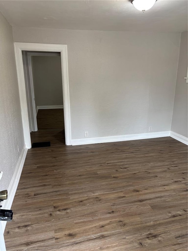8324 Strathmore Pl, Jennings, MO 63136 - spare room with baseboards and dark wood-style floors