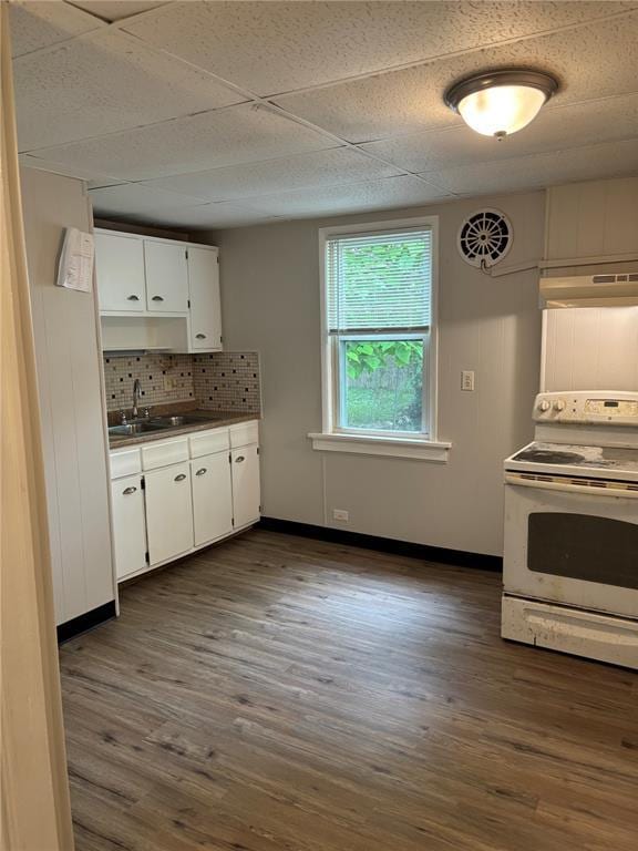 8324 Strathmore Pl, Jennings, MO 63136 - kitchen featuring white range with electric stovetop, under cabinet range hood, a sink, white cabinetry, and dark wood-type flooring