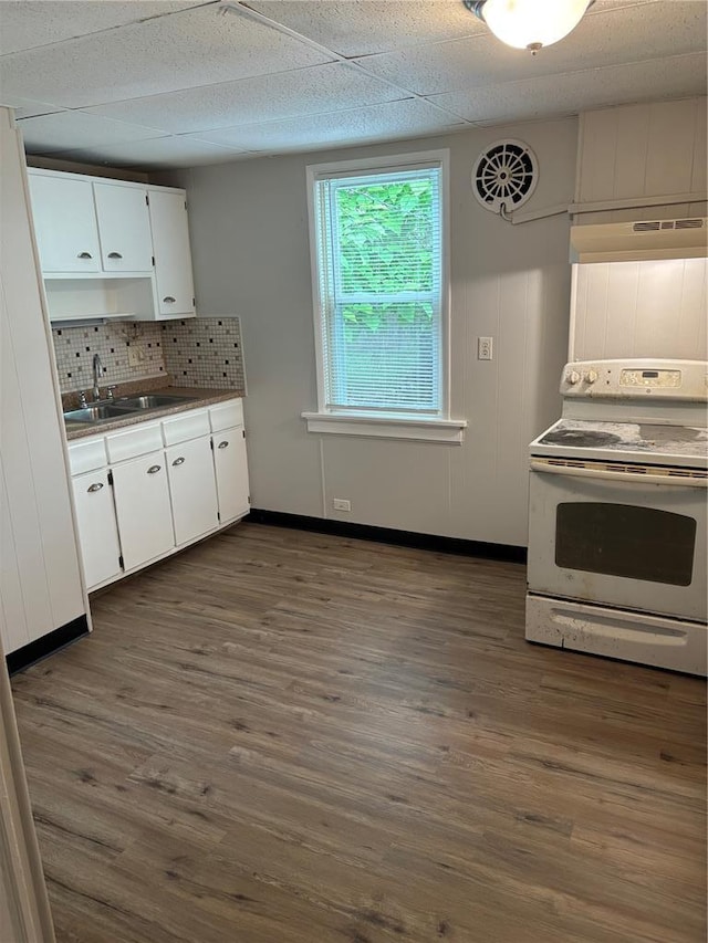 8324 Strathmore Pl, Jennings, MO 63136 - kitchen featuring white electric range oven, a sink, white cabinets, and dark wood-type flooring