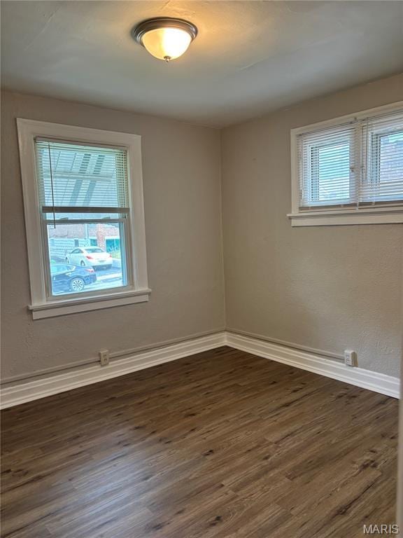 8324 Strathmore Pl, Jennings, MO 63136 - unfurnished room with dark wood-style floors and baseboards