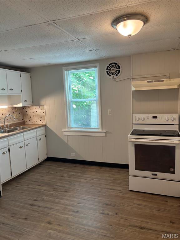 8324 Strathmore Pl, Jennings, MO 63136 - kitchen with white electric range oven, under cabinet range hood, white cabinetry, and dark wood finished floors