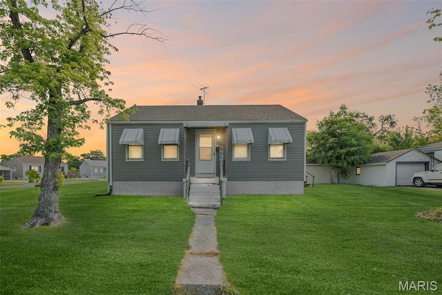 100 Bonds Ave, East Alton, IL 62024 - bungalow-style house with a front lawn, entry steps, and a chimney