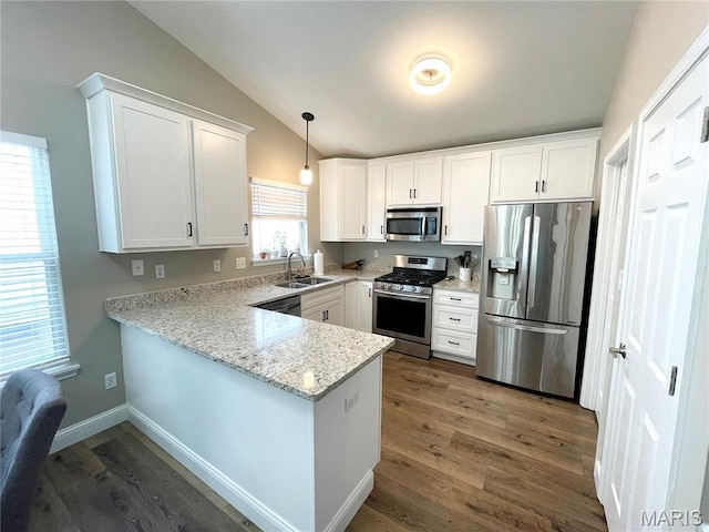 259 Jacob Ln, Ballwin, MO 63021 - kitchen featuring appliances with stainless steel finishes, lofted ceiling, a sink, a peninsula, and white cabinets