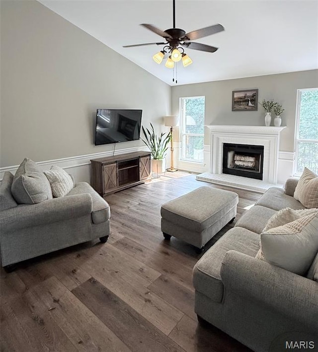 259 Jacob Ln, Ballwin, MO 63021 - living room with a fireplace with raised hearth, lofted ceiling, plenty of natural light, wainscoting, and wood finished floors