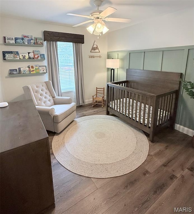 259 Jacob Ln, Ballwin, MO 63021 - bedroom featuring wood finished floors, a crib, and a ceiling fan