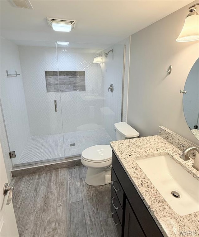 259 Jacob Ln, Ballwin, MO 63021 - bathroom featuring wood finished floors, vanity, a stall shower, and toilet