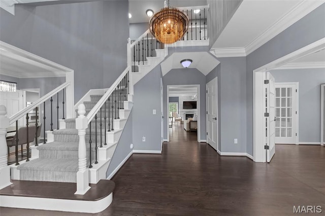 16434 Wilson Farm Dr, Chesterfield, MO 63005 - foyer entrance featuring a chandelier, stairs, wood finished floors, crown molding, and baseboards