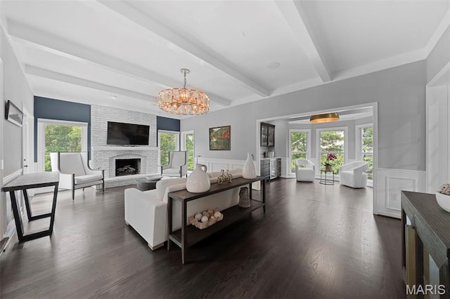 16434 Wilson Farm Dr, Chesterfield, MO 63005 - living area featuring beamed ceiling, a decorative wall, a chandelier, a large fireplace, and a wainscoted wall