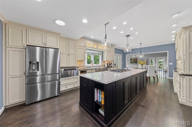 16434 Wilson Farm Dr, Chesterfield, MO 63005 - kitchen with appliances with stainless steel finishes, dark cabinets, a center island, cream cabinetry, and dark wood-style floors
