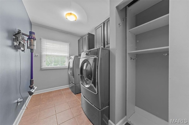 16434 Wilson Farm Dr, Chesterfield, MO 63005 - washroom with washing machine and dryer, light tile patterned floors, cabinet space, and baseboards