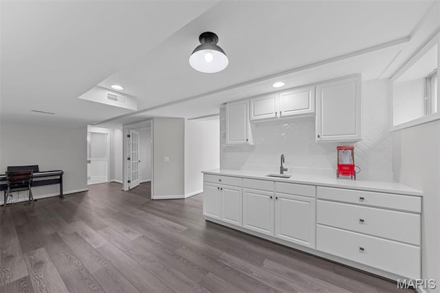 16434 Wilson Farm Dr, Chesterfield, MO 63005 - kitchen featuring light countertops, a sink, white cabinetry, recessed lighting, and baseboards