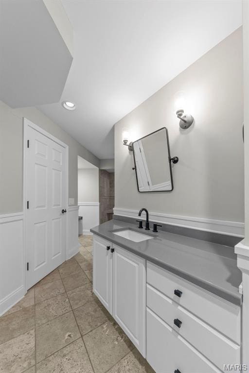 16434 Wilson Farm Dr, Chesterfield, MO 63005 - bathroom featuring vanity, stone tile flooring, recessed lighting, and baseboards