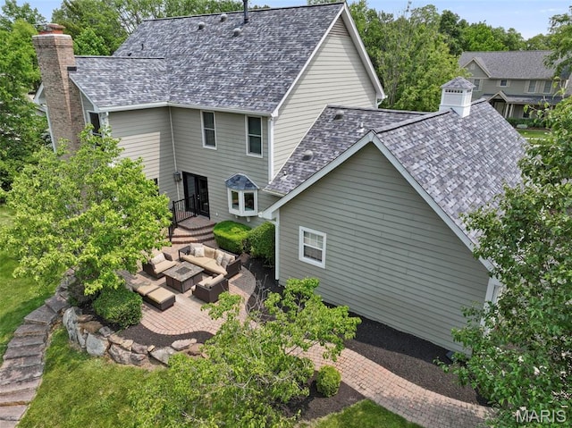 16434 Wilson Farm Dr, Chesterfield, MO 63005 - rear view of property with an outdoor living space, a patio area, roof with shingles, and a chimney