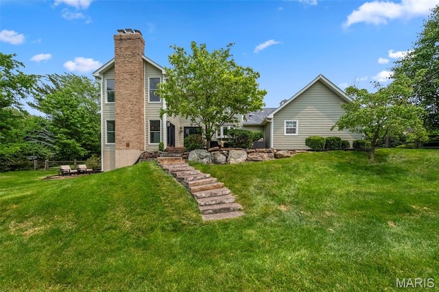 16434 Wilson Farm Dr, Chesterfield, MO 63005 - rear view of house with a chimney and a lawn
