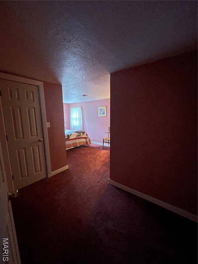 623 County Road 6590, Salem, MO 65560 - unfurnished bedroom with carpet floors, a textured ceiling, and baseboards