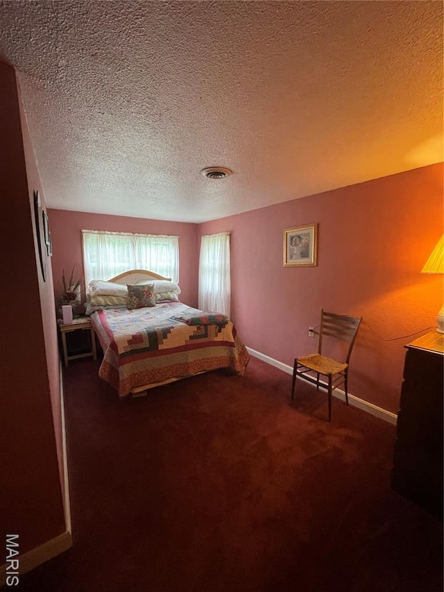 623 County Road 6590, Salem, MO 65560 - carpeted bedroom featuring a textured ceiling and baseboards