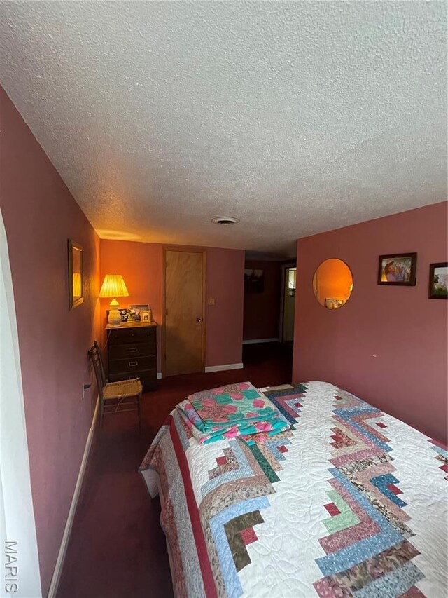 623 County Road 6590, Salem, MO 65560 - bedroom with a textured ceiling, dark colored carpet, and baseboards