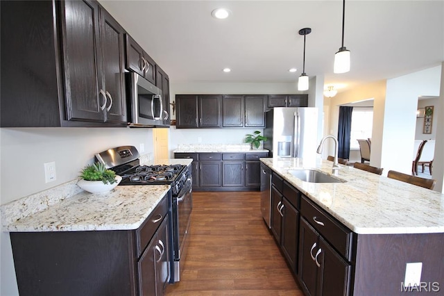 1030 Remington Dr, Imperial, MO 63052 - kitchen featuring stainless steel appliances, dark wood-type flooring, dark brown cabinetry, an island with sink, and recessed lighting