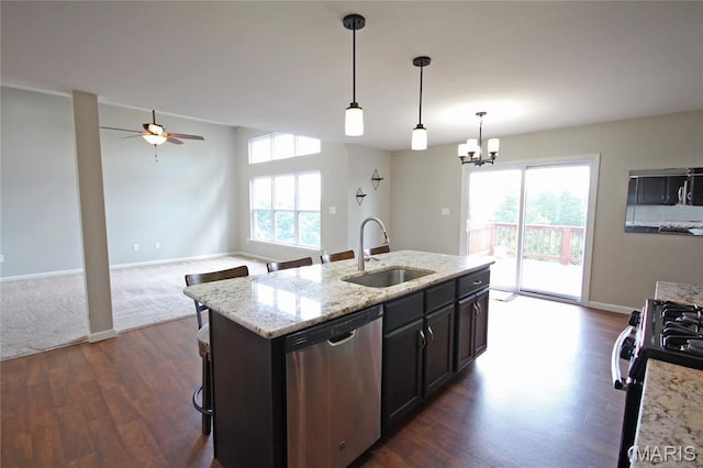1030 Remington Dr, Imperial, MO 63052 - kitchen with dishwasher, dark wood-style flooring, gas range, ceiling fan, and hanging light fixtures