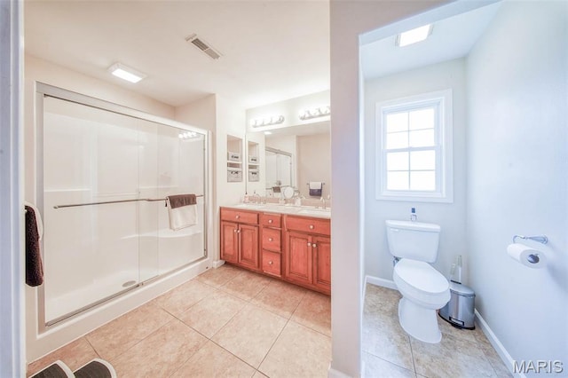 11195 Lexington Ln, Rolla, MO 65401 - full bath with double vanity, tile patterned flooring, a stall shower, toilet, and baseboards