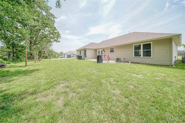 11195 Lexington Ln, Rolla, MO 65401 - back of house with a patio area, a yard, central AC unit, and a playground