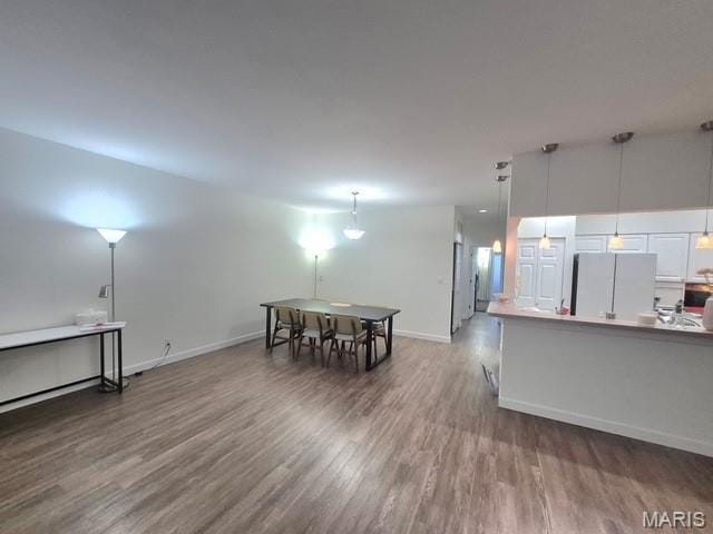 4465 W Pine Blvd Unit 15, Saint Louis, MO 63108 - kitchen featuring freestanding refrigerator, wood finished floors, and pendant lighting