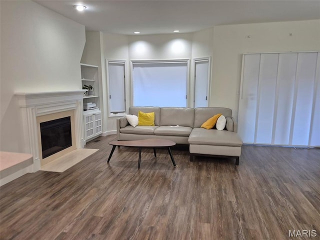 4465 W Pine Blvd Unit 15, Saint Louis, MO 63108 - living area featuring wood finished floors, built in features, a fireplace with flush hearth, and recessed lighting