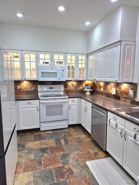 4465 W Pine Blvd Unit 15, Saint Louis, MO 63108 - kitchen with white appliances, dark countertops, white cabinets, and recessed lighting