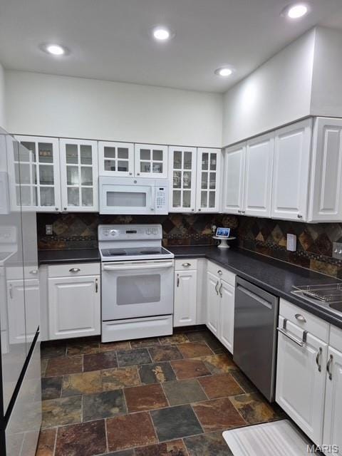 4465 W Pine Blvd Unit 15, Saint Louis, MO 63108 - kitchen featuring white appliances, dark countertops, backsplash, glass insert cabinets, and recessed lighting