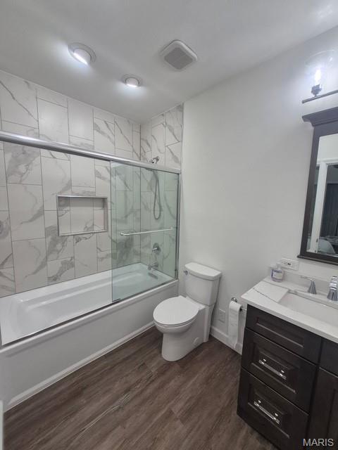4465 W Pine Blvd Unit 15, Saint Louis, MO 63108 - full bathroom featuring vanity, shower / bath combination with glass door, and wood finished floors