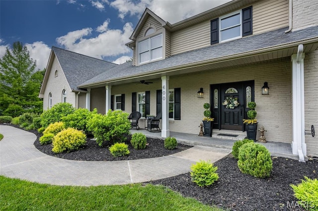 600 E Waters Edge Dr, Shiloh, IL 62221 - property entrance featuring covered porch, brick siding, ceiling fan, and a shingled roof